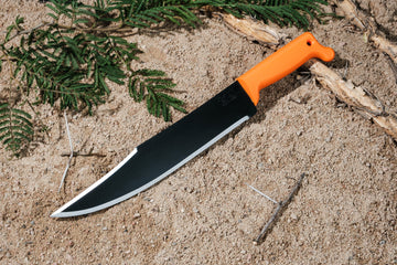 Okapi Bowie Machete knife with Okapi orange handle on sandy background
