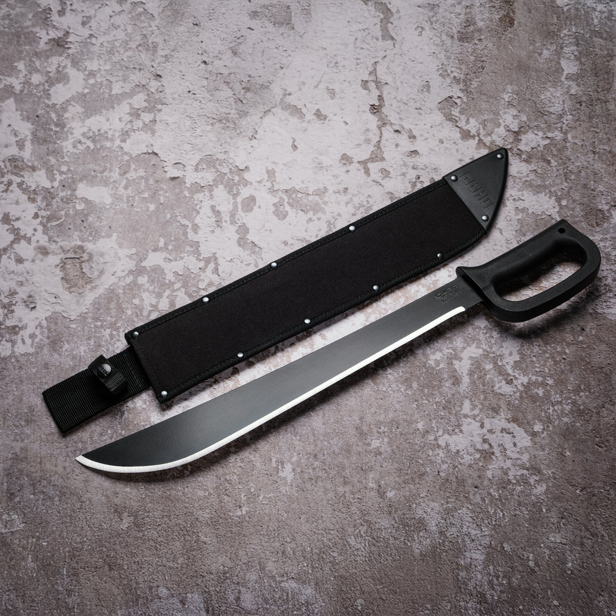Okapi D-Ring Machete with black handle with black Sheath on grey background