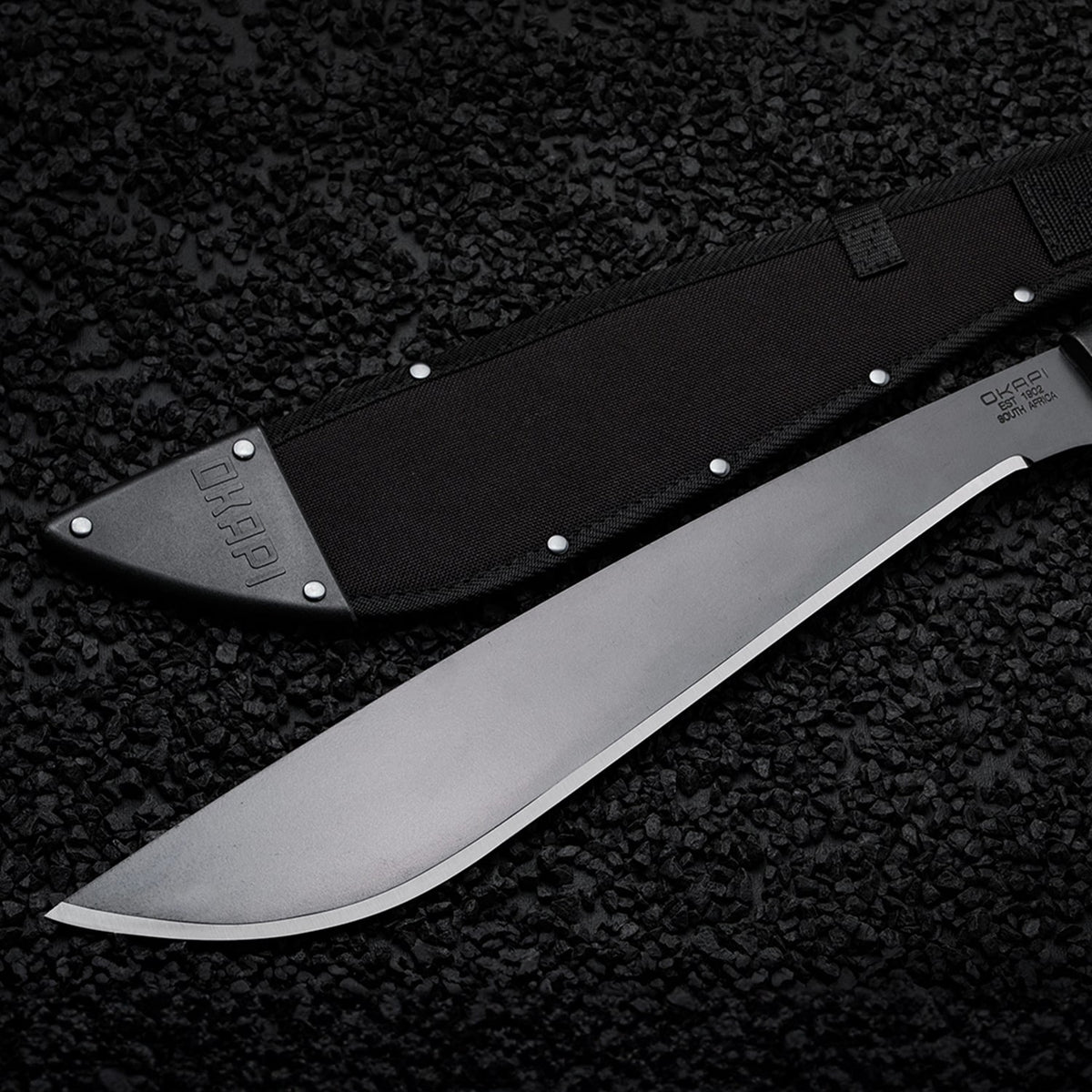 Okapi Jungle Machete Sheath in black on black stone background