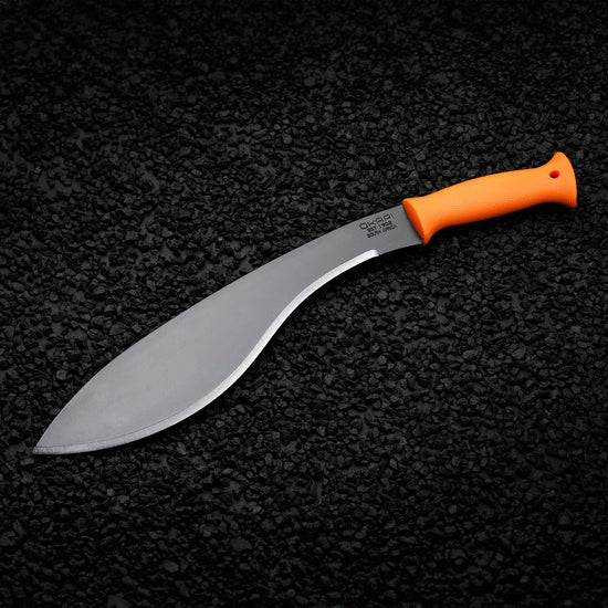 Okapi Orange handled Okapi Kukri-style machete resting on black rock floor