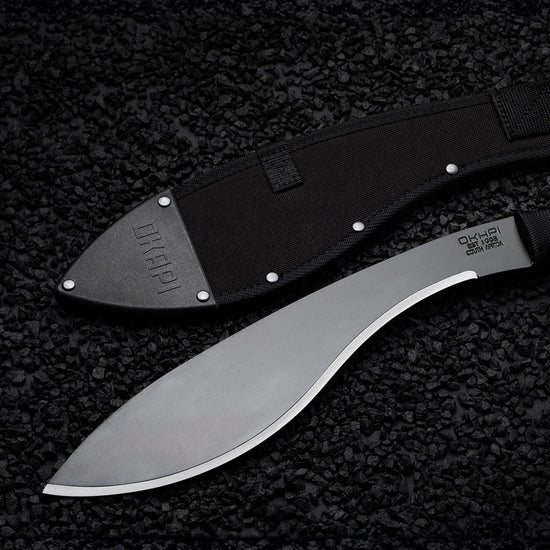 Okapi Kukri Machete Sheath in black on a black stone flooring