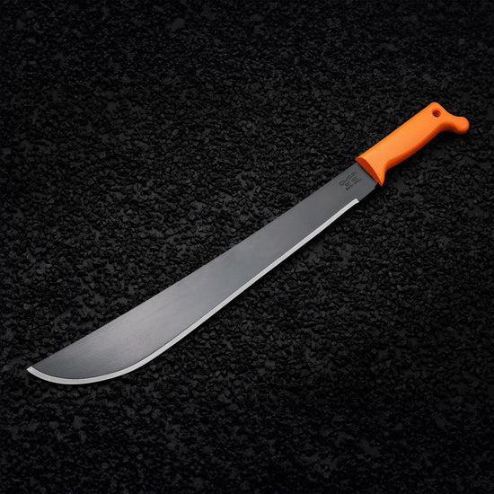 Okapi Latin-style machete with Okapi orange grip featured on black rock lifestyle scene