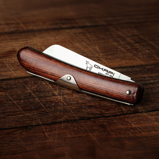 Close-up Okapi Biltong Knife folded on wooden background