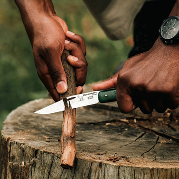 Okapi Folding Knife with Forest green handle in outdoor environment