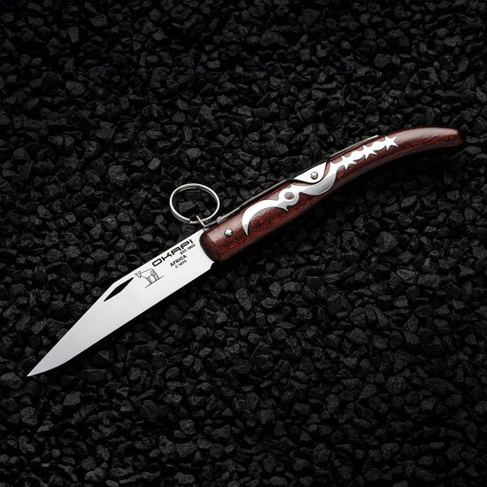 Opened Okapi Lock Knife with wooden handle on black stone background